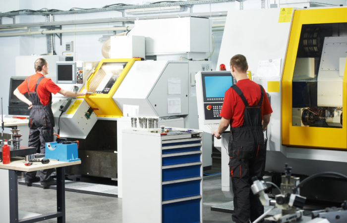 Mechanical Technicians Working At Cnc Milling Machine Center In Tool Workshop